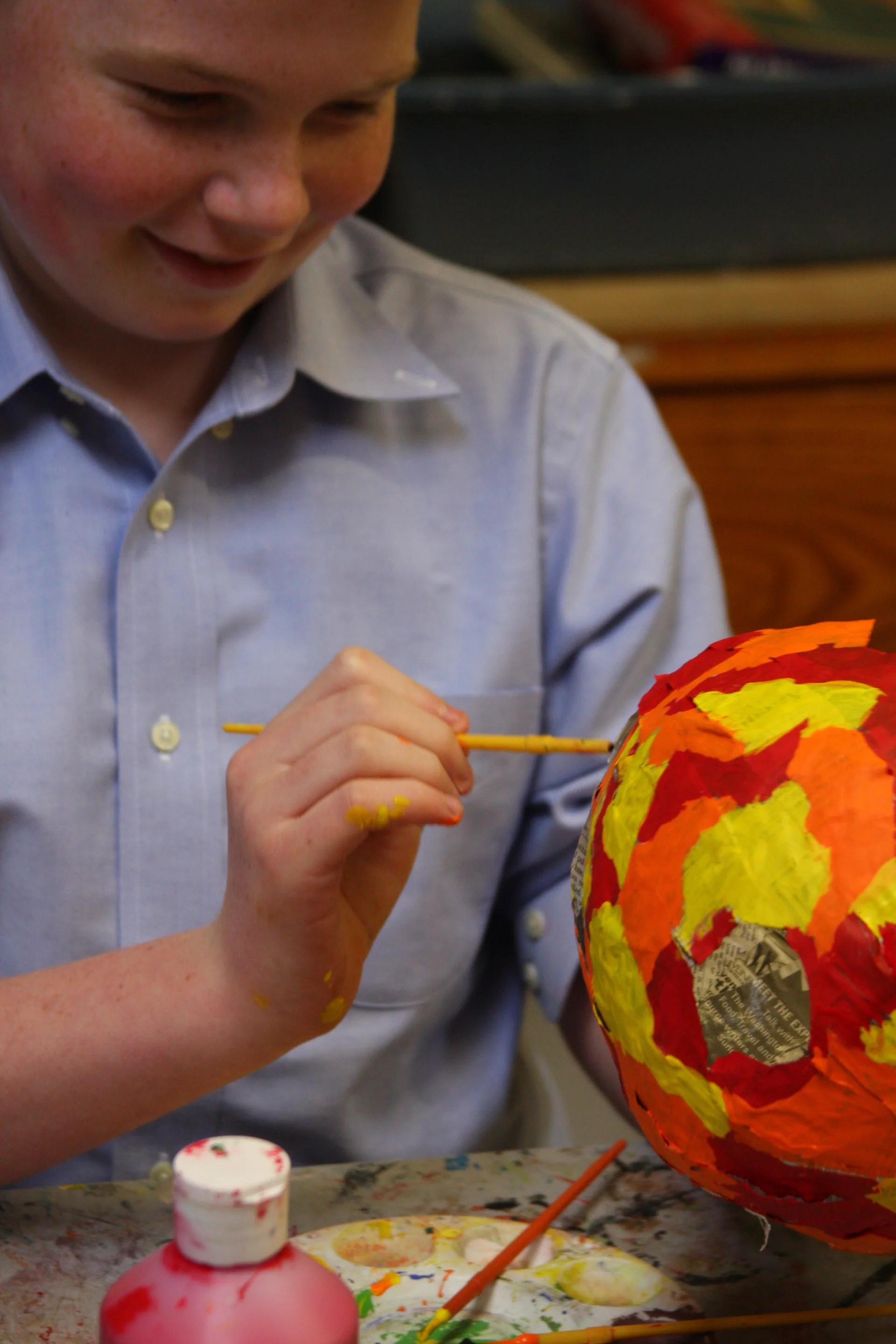 student doing paper mache